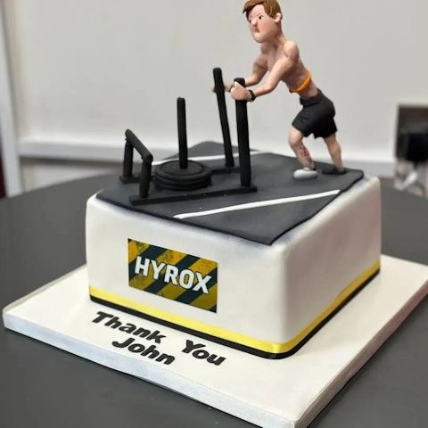 A cake featuring an icing model of John Carroll taking part in the HYROX event