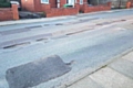 Potholes on at street in Rochdale before being repaired